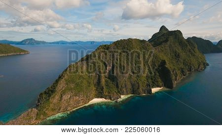 Tropical islands, aerial view. Aerial view: sea and the tropical islands. Tropical bay in El Nido. Archipelago El Nido.Sandy beaches of the wild islands. Philippines National Marine Park. Seascape: sky, clouds and mountains rocks, ocean. Sea landscape. Tr