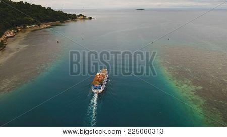 Aerial view passenger ferry floats in the blue sea.Asian passenger boat floating in the ocean.Philippines, Camiguin. Passenger ferry boat Camiguin to Mindanao. Travel concept.