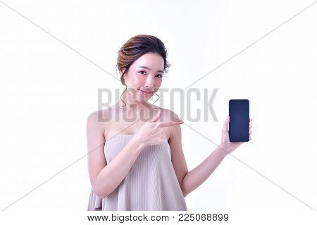 The concept of healthy beautiful woman. Beautiful women keep healthy. Beautiful woman hands holding the mobile phone. Beautiful young woman using finger pointing at mobile phone.