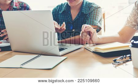 University Students Using Laptop Meeting For Research Homework In College
