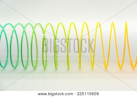 BANGKOK, THAILAND - JAN 31, 2018 : Rainbow slinky toy Isolated on white background. Illustrative editorial.