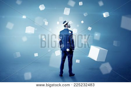 Handsome businessman with vr goggle and falling white cubes around
