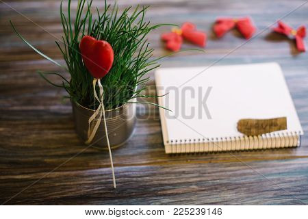 Still-life to the day of the holy valentine on a wooden background.