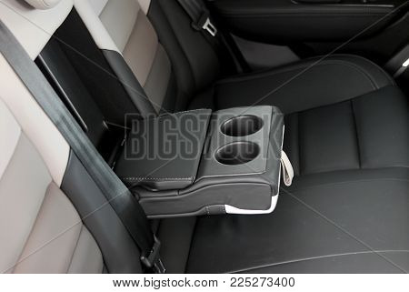 armrest in car with cans open, rear seats