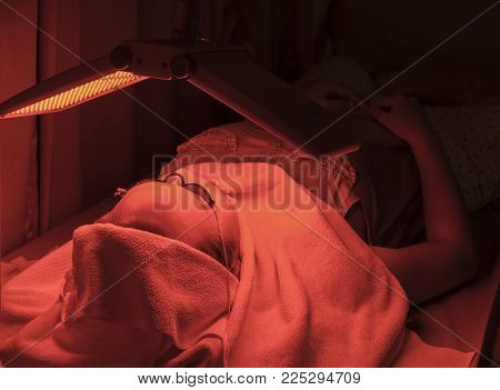 a facial face by photodynamic therapy in clinic.