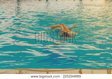 young man swimming freestyle at the pool.sport concept
