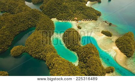 Aerial view: Bucas Grande Island, Sohoton Cove. Philippines. Tropical sea bay and lagoon, beach. Tropical landscape hill, clouds and mountains rocks with rainforest. Azure water of lagoon. Shore Landscape Bay. Aerial video.Seascape. Travel concept.