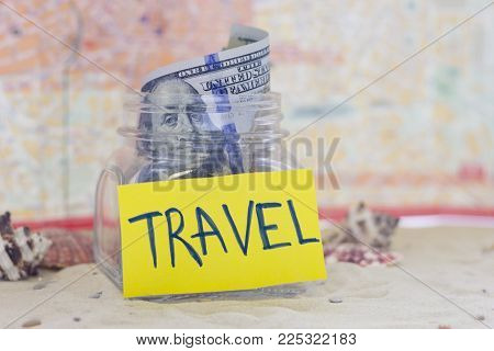 Planning for vacation, saving money for next trip. Sand background