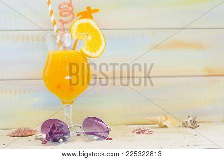 Planning for vacation, saving money for next trip. Romantic coctail and sunglasses on white sand background