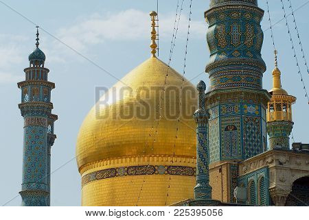 QOM, IRAN - JUNE 26, 2007: View to the minarets of the Fatima Masumeh Shrine in Qom, Iran. Shia Muslims consider Qom as  one of the most sacred cities in Iran.
