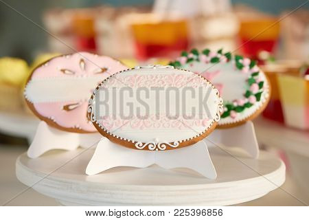 Set Of A Three Gingerbread Cookies, Covered With White Glaze And Decorated With Different Patterns A