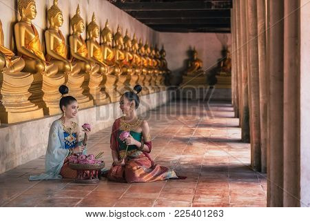 Ayutthaya, Thailand - December 17: Two Women In Antique Dress With Gold Jewelry That Squat At The Fl