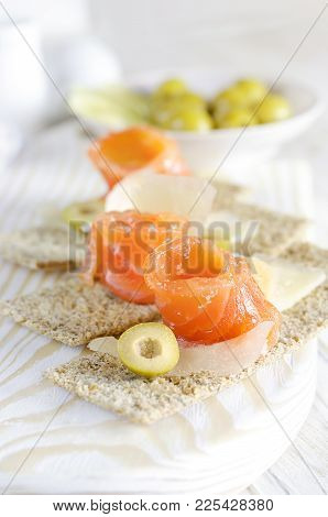 Delicious Appetizer Canapes With Salmon, Cheese And Olive.