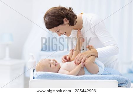 Mother And Baby On Changing Table