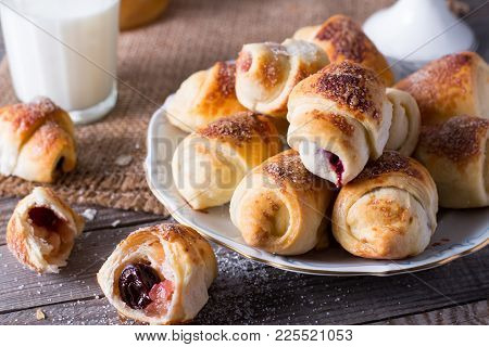 Rugelach With Jam Filling On Plate With Milk On Wooden Background - A Traditional Pastry