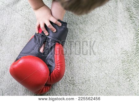 Boxing Gloves In The Hands Of A Little Boy.