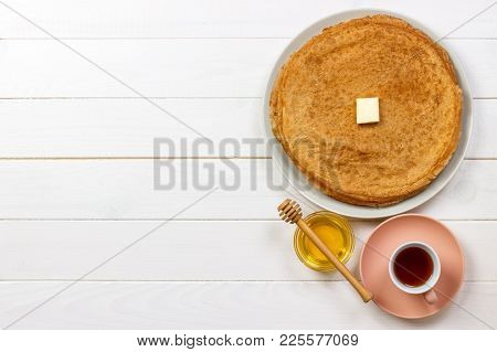 Hot Pancakes With Butter And Honey On A Plate. Breakfast With Tea And Crepes. Top View With Copy Spa
