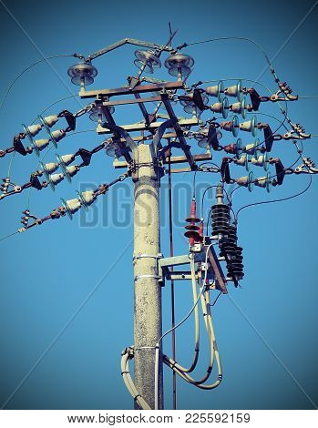 Big Switches Of An Overhead Power Line With  Concrete Pole And Electrical Insulators Made In Ceramic