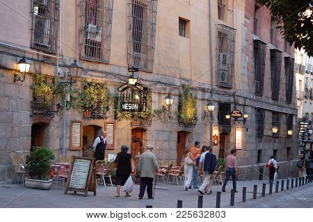 Passersby In Front Of The Meson Rincon De La Cava Tapas Restaurant Off Plaza Mayor - Madrid, Spain, 