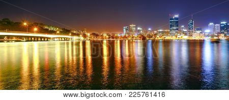 Panorama Of Narrows Bridge And Perth Skyline Illuminated At Night. Perth Downtown Cityscape With Sky