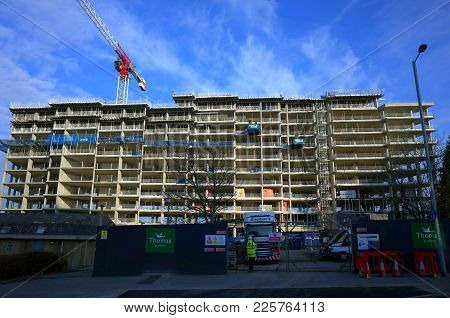 Bracknell, England - January 31, 2018: A Site Worker And A Large Truck At The Gate Of A Construction
