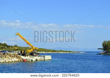 Antipaxos Harbour, Greece - October 01, 2017 : A Mobile Crane On Antipaxos A Small Island South Of C
