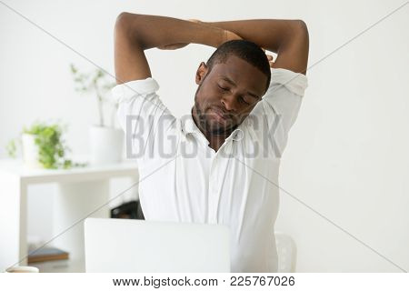 African American Man Stretching Doing Easy Office Exercises To Relieve Muscle Tension From Sedentary