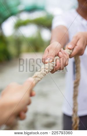 Two Hands Pulling Rope In Oppisite Direction