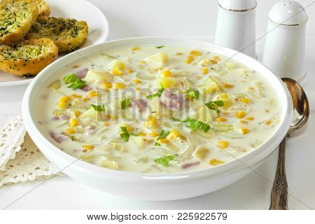 Corn Chowder - Creamy Corn Chowder With Ham And Potatoes, Served With Crunchy Garlic Bread.