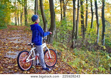 A Young Cyclist Stands On A Sunny Day By Bicycle In The Nature