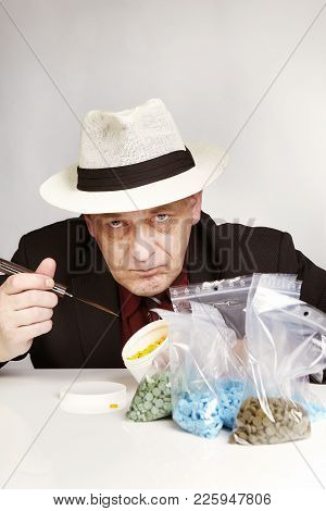 Older Dealer Of Mdma Drugs Counting Lot Of Pills