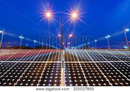 Texture Of Photovoltaic Panels Solar Panel With City Night Light On The Road At Night Background, Al