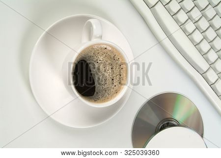 Cup Of Coffee, Dcs And Keyboard On A Studio Background