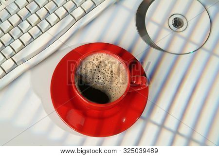 Cup Of Coffee, Dcs And Keyboard On A Studio Background