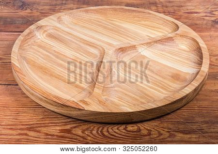 Empty Round Compartmental Dish With Three Departments Made With Oak Wood On The Old Rustic Table