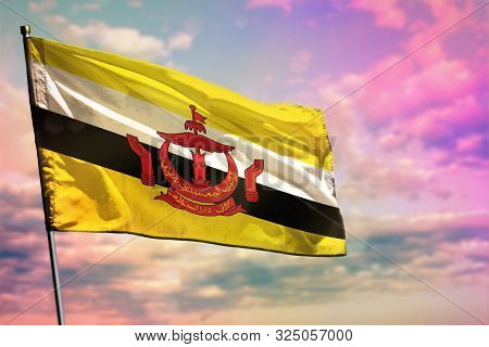 Fluttering Brunei Darussalam Flag On Colorful Cloudy Sky Background. Brunei Darussalam Prospering Co