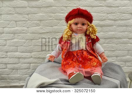 A Toy Doll Is Sitting On The Table.