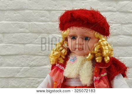 A Toy Doll Is Sitting On The Table.