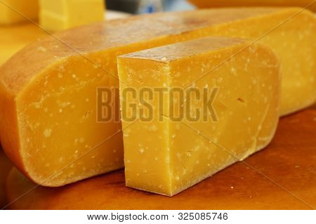 Close Up Cut Slices And Wheel Of Hard Extra Old Matured Yellow Gouda Dutch Cheese, Low Angle View