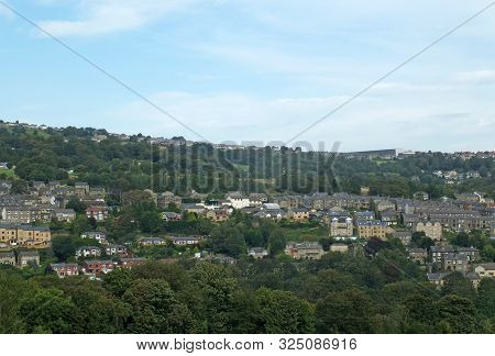A Panoramic View Of Sowerby Bridge From Above Surrounded Trees And A Blue Summer Sky