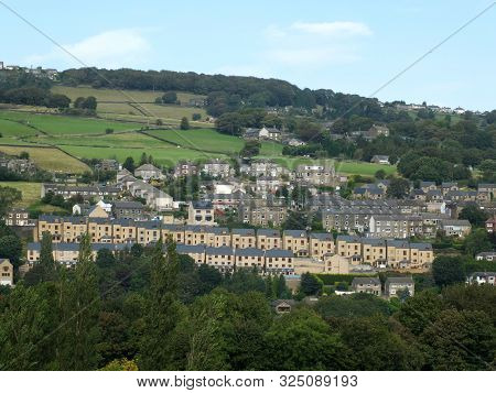 A Row Of Modern Houses Build On A Hillside Surrounded By Older Buildings In Sowerby Bridge West York
