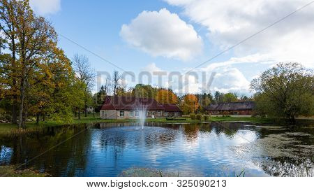 Luznava, Latvia, Autumn Landscape With Pond And Fountain.