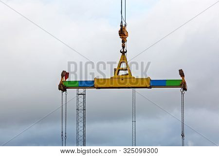 Container Spreader Device Hooked At Crane In Port