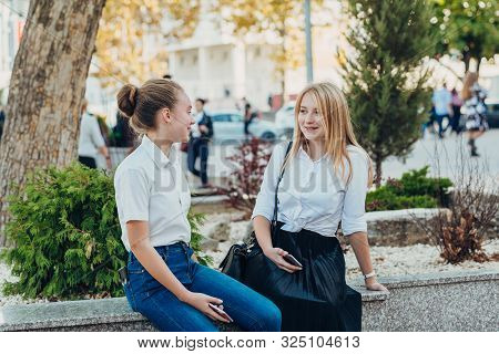 Happy Brightful Positive Moments Of Two Stylish Girls Hugging On Street In City. Closeup Portrait Fu