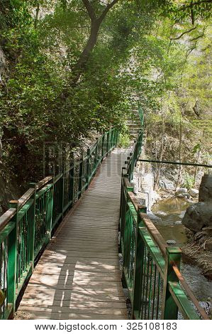 Small Bridge Next To Milomeris Waterfall, Cyprus, Surrounded By Trees, With Sun Light Come Throug. V