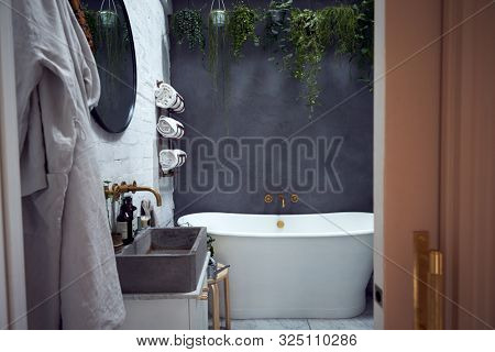 Empty Interior Of Contemporary Bathroom With Free Standing Bath Viewed Through Doorway