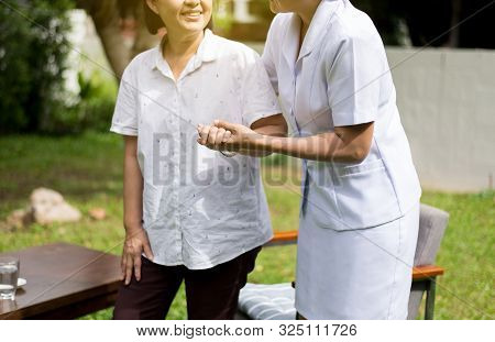 Nurse Holding Hands To Elderly Asian Woman With Alzheimer Disease,positive Thinking,happy And Smilin