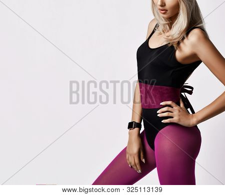 Closeup Of Portrait In Profile Of Stylish Athletic Blonde Woman In Purple Sports Wear Bodysuit And L