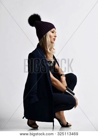 Glamorous Woman Blonde In Velvet Plush Bralet, Blue Jacket, Pants, High Heels Shoes And Knitted Wint