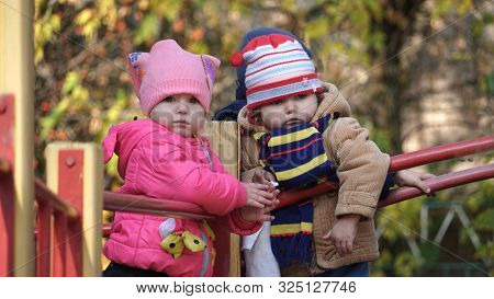 Children Plays On A Playground In The Park. Happy Child On The Childscape Outdoors Inautumn.